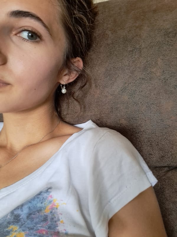 Woman relaxes with drink on couch in Bulgarian home