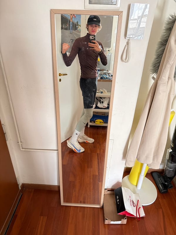 Large mirror spotted against wall in Milan indoor space