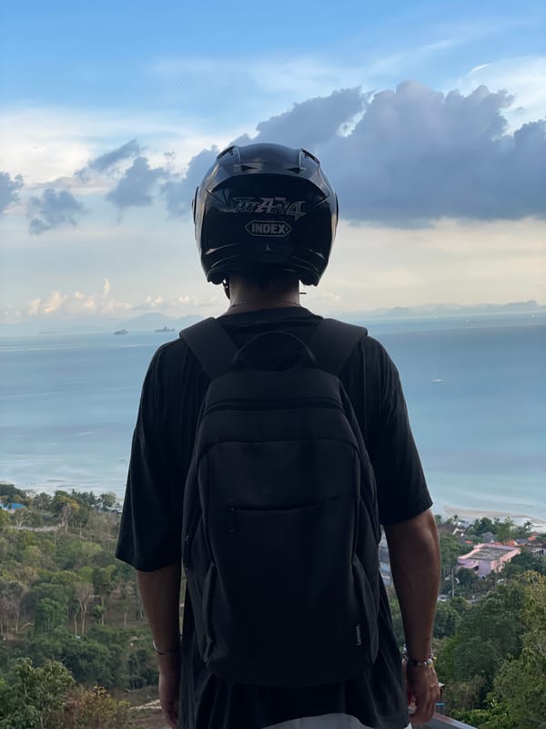 Helmeted visitor takes in coastal views at Thai seaside town