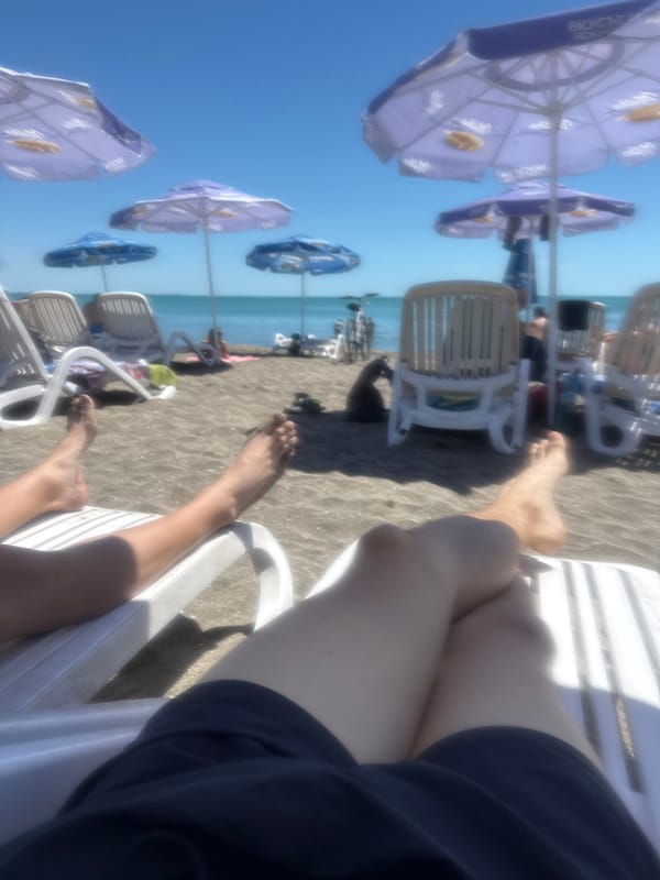 Beachgoers relax on sunbeds in Burgas, Bulgaria