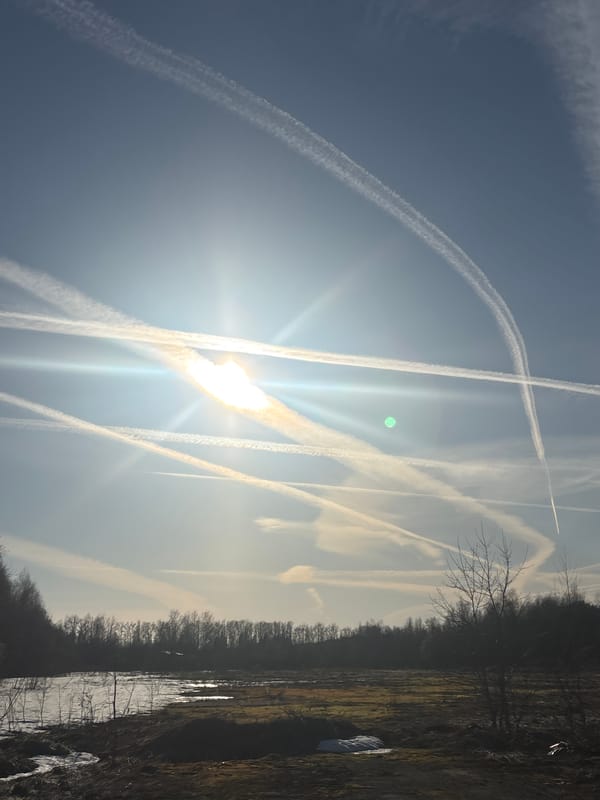 Multiple aircraft contrails create abstract sky pattern over Russia