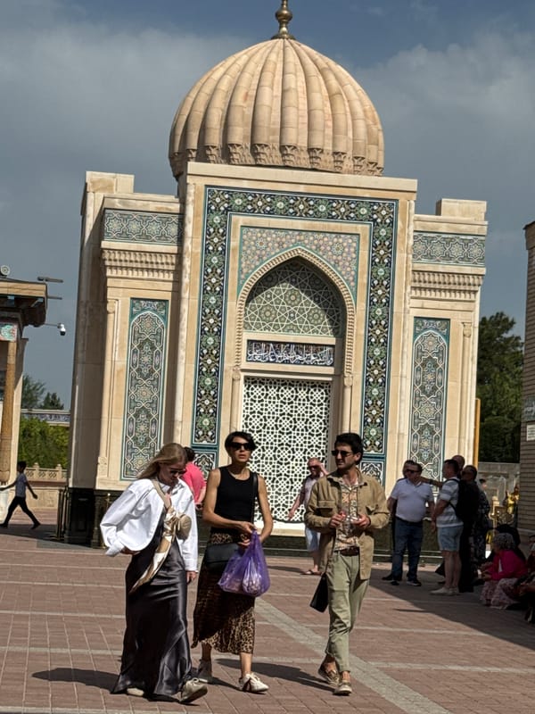 Tourist documents historic Islamic architecture in Samarkand, Uzbekistan