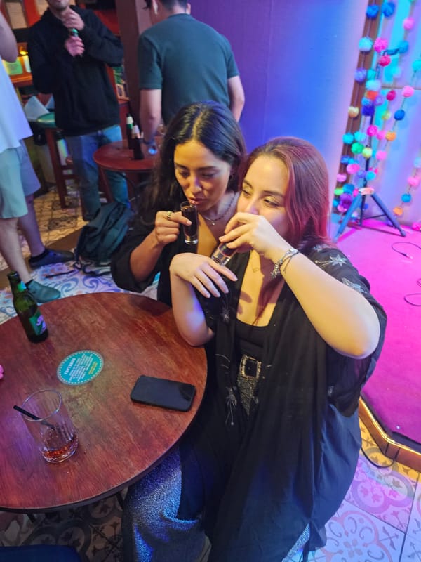 Women share drinks at morning gathering in Miraflores bar