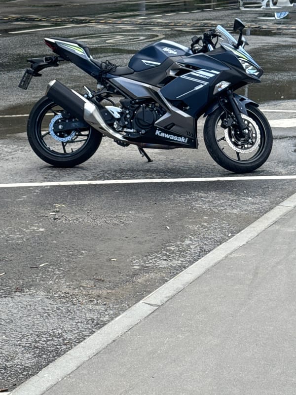 Street-level moments: a parked motorcycle, skyward glance, and elevator selfie