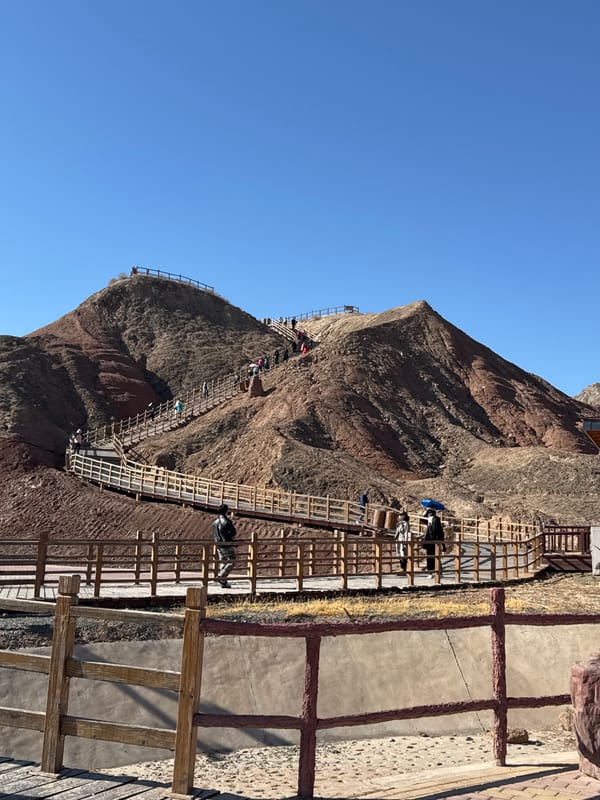Tourists explore red mountain walkways in Nantai, China
