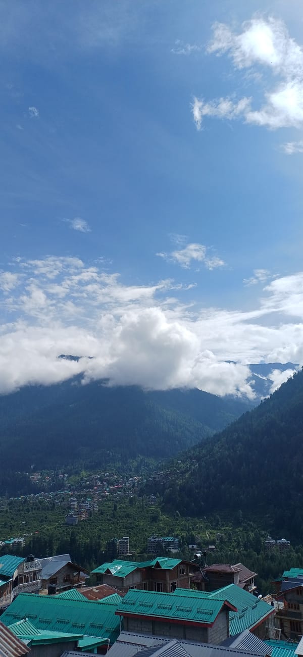 Mountain valley town photographed from multiple angles on a cloudy day
