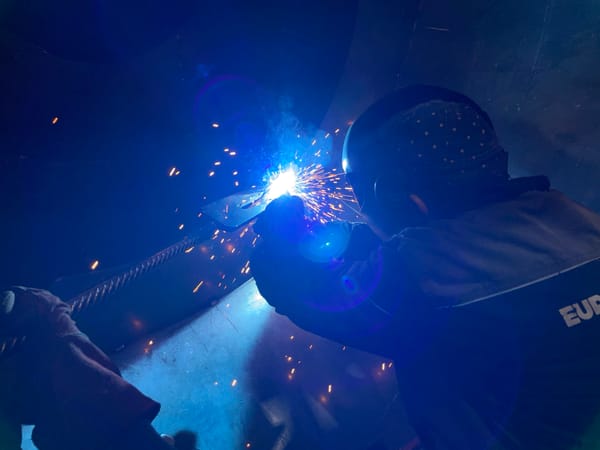 Welder performs morning metalwork in Montenegro industrial workshop