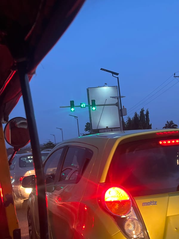 Evening traffic captured in Galadimawa, Nigeria street scene