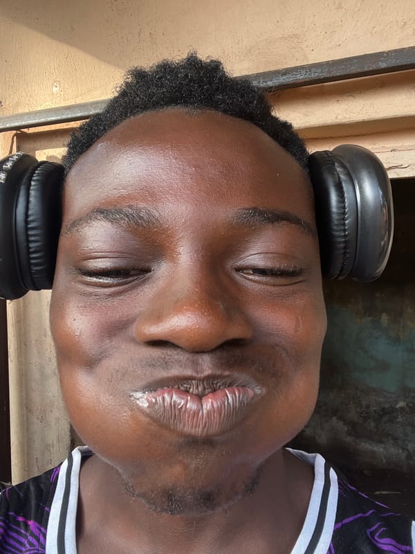 Young man resting with headphones observed in Obosi