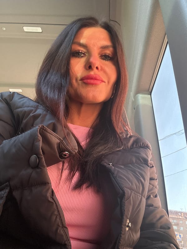 Woman in pink sweater observed inside vehicle in Gornozavodsk