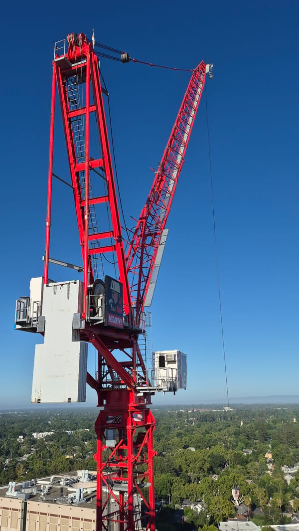 Red tower crane rises over Sacramento skyline