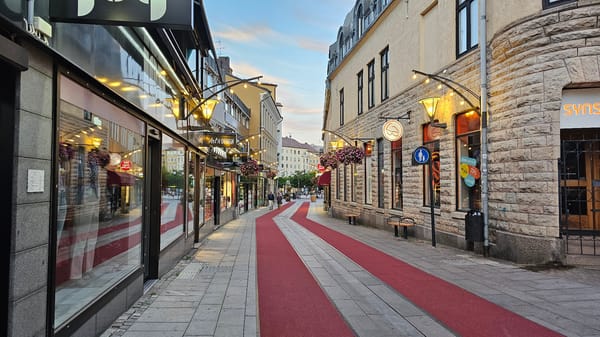 Linköping pedestrian street at dusk, red carpet and art installation