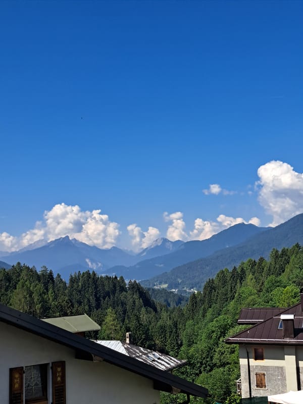 Alpine village morning: mountains, meadows, and old-town streets
