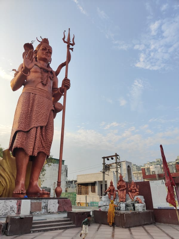 Temple visit in Gurgaon — Shiva statue, shrines, and deity altars