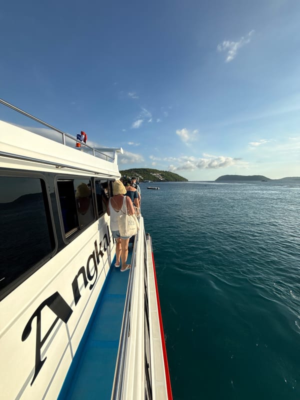 Tourists sightsee from boat near Kampung Toyapakeh, Indonesia