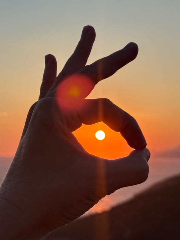 Sunset over the Adriatic, framed through hands and lenses