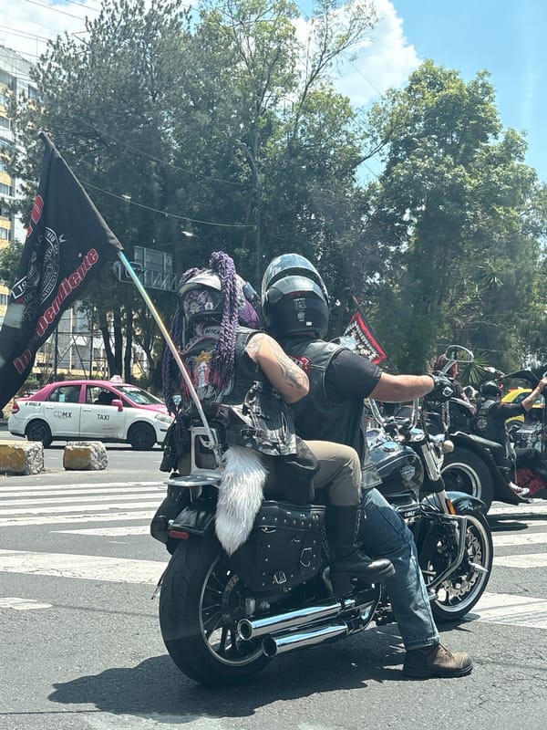 Motorcyclists stop at Mexico City intersection during evening traffic