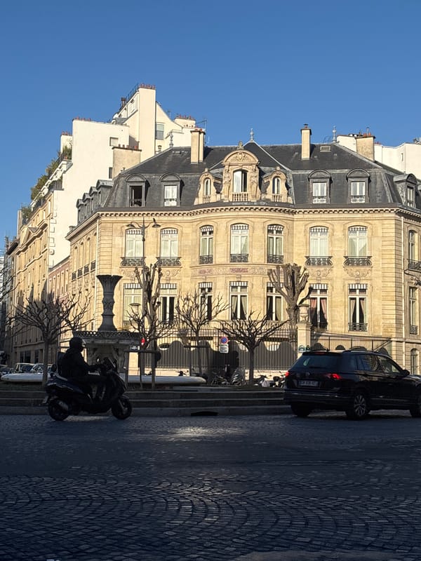 Morning street scene with parked vehicles in Paris