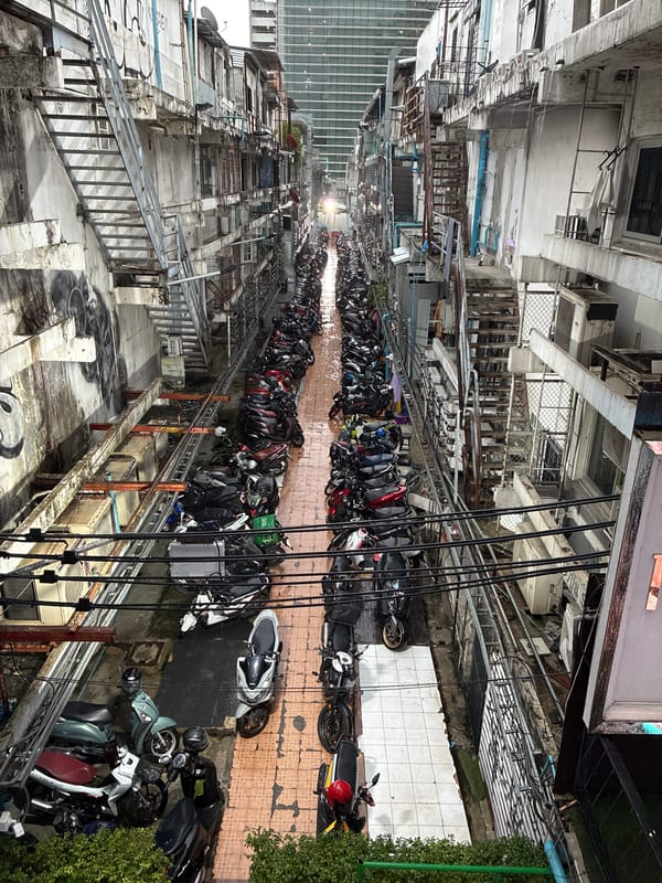Rainy Bangkok streets: tight alleys and overpass traffic