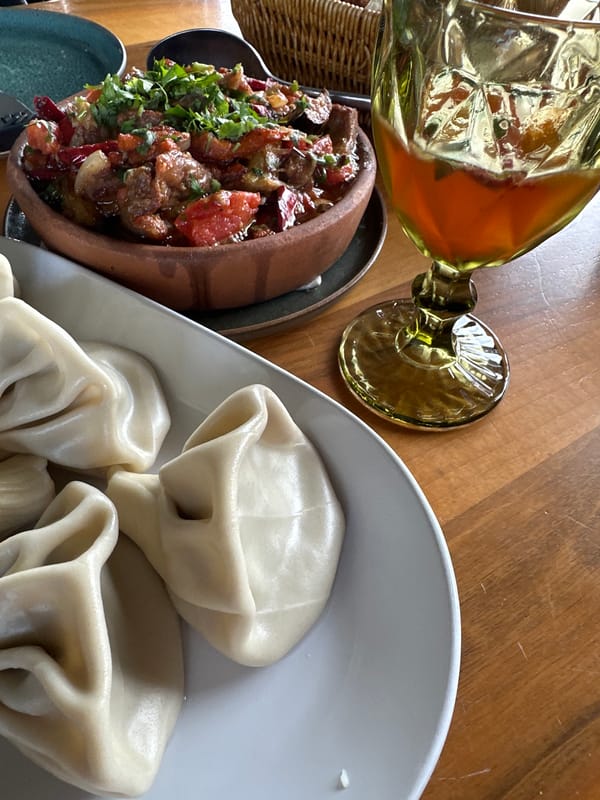 Woman documents traditional Georgian meal at Marneuli restaurant
