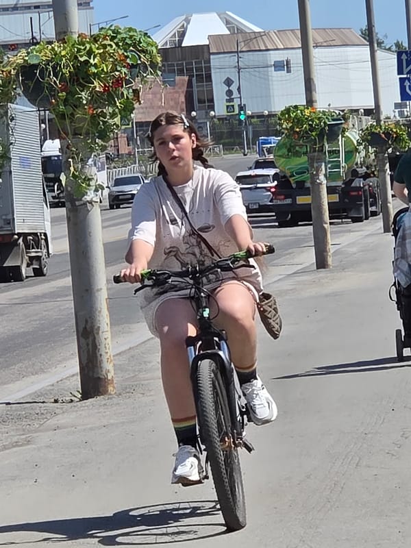 Everyday city life: cyclists, pedestrians, and street scenes on a sunny day