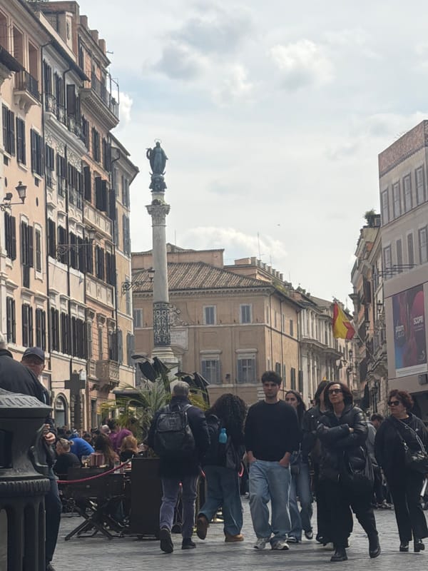 Historic Roman street scene captured with Spanish flag visible