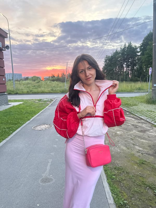 Sunset poses on a paved walkway, pink skies overhead