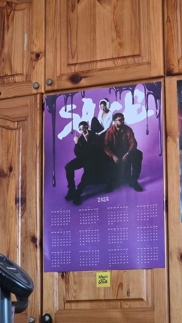 Purple poster with stacked figures spotted on wooden cabinet