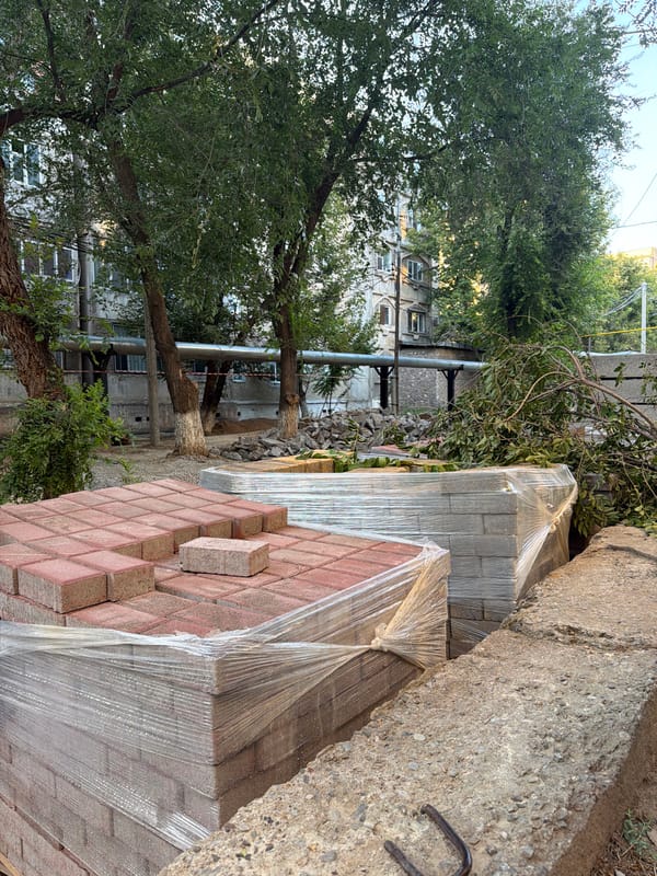 Paving stones and construction debris outside a Shymkent apartment block