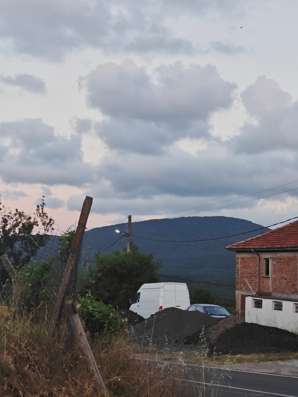 Dusk in rural Izgrev: full moon rises over fields and forgotten machinery