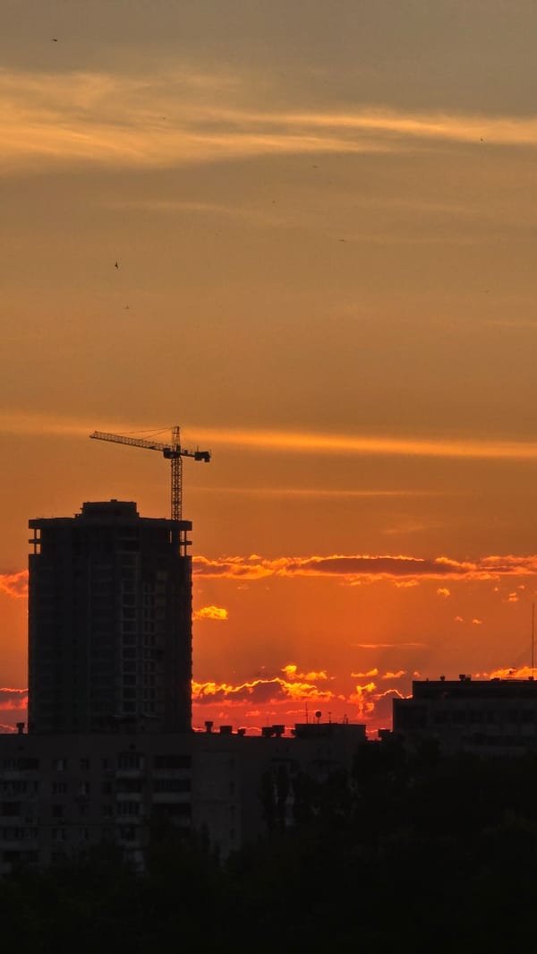 Warm orange sunset lights up the Kyiv sky