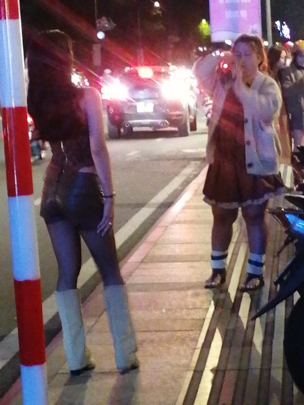 Nighttime streets of Da Lat, crowds out and moving