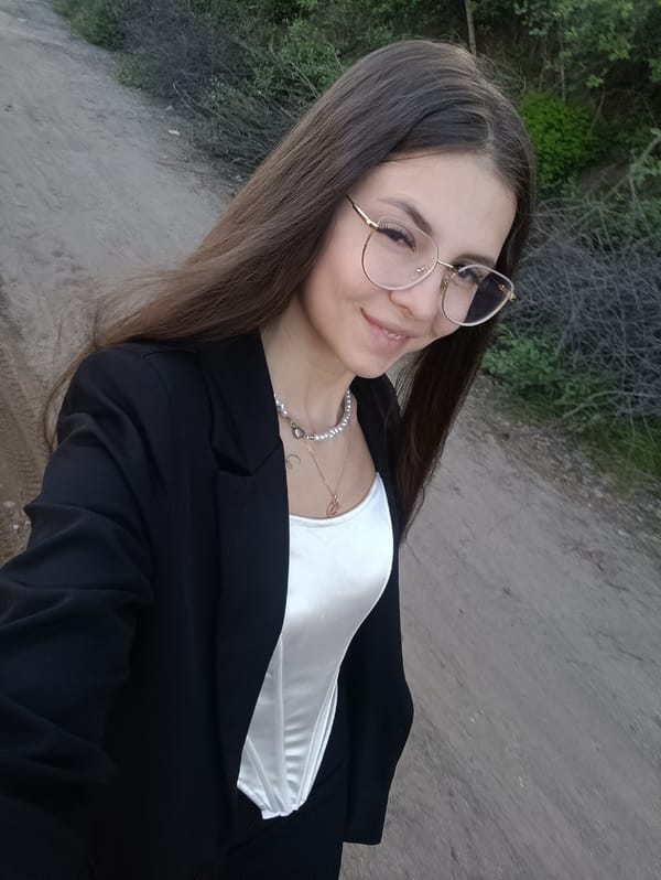 Woman poses for photo on dirt road