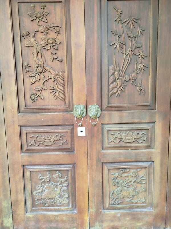 Ornate carved wooden doors documented in Ho Chi Minh City