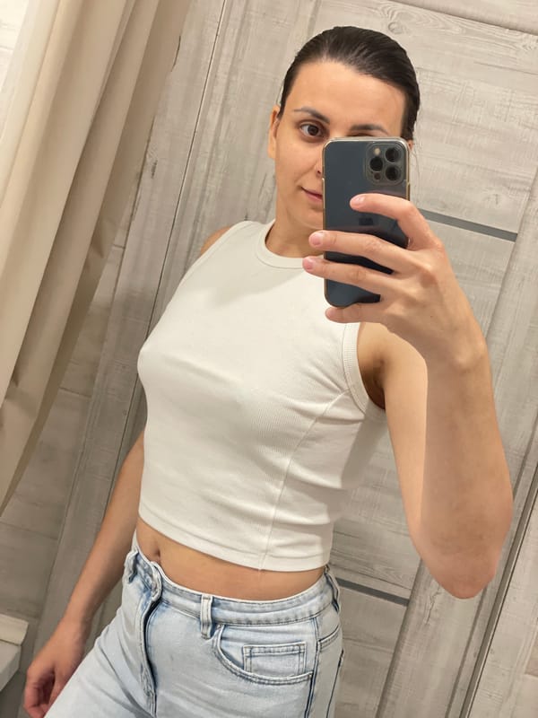 Woman takes bathroom selfies, urban rain scene documented simultaneously