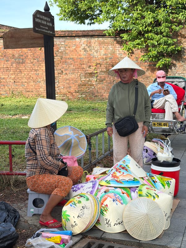 Nón lá vendor near ancient brick archway, Phú Xuân Ward