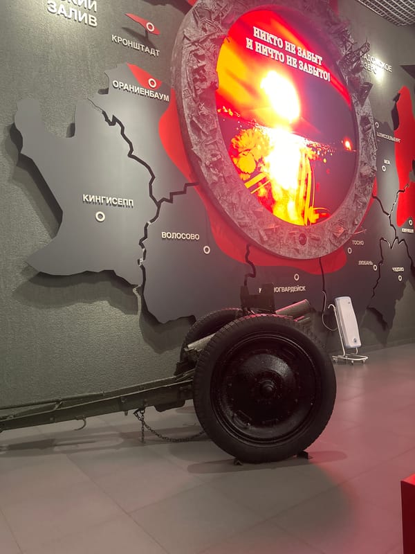 Military history museum exhibit in Kirovsk displays artillery and maps