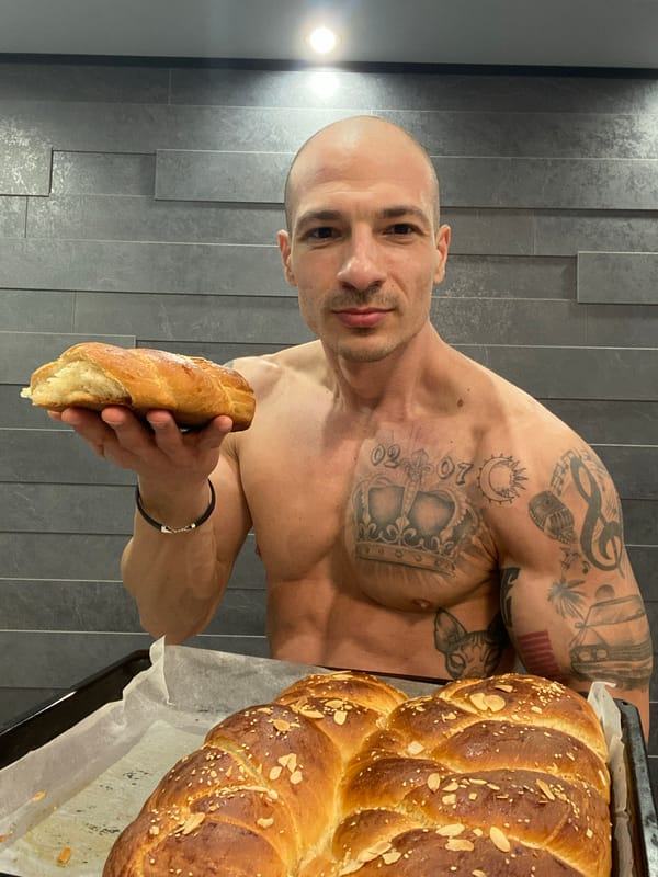Tattooed baker displays fresh bread in Pleven