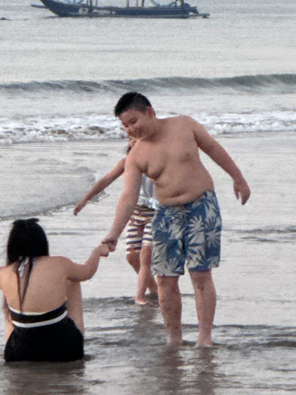 Sunset at Jimbaran Bay: horses, beachgoers, and seafood dining