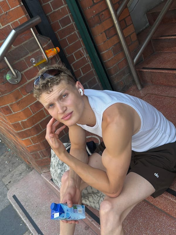 Chilling on London outdoor steps, phone in hand