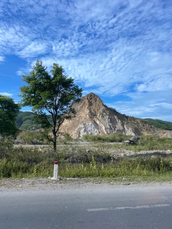 Lone tree faces heavily quarried mountain in Cam Lộ, Vietnam