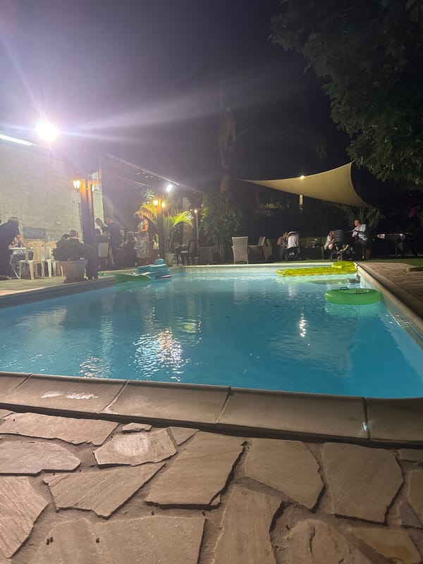 Nighttime pool scene glowing under lights in Pervolia, Cyprus