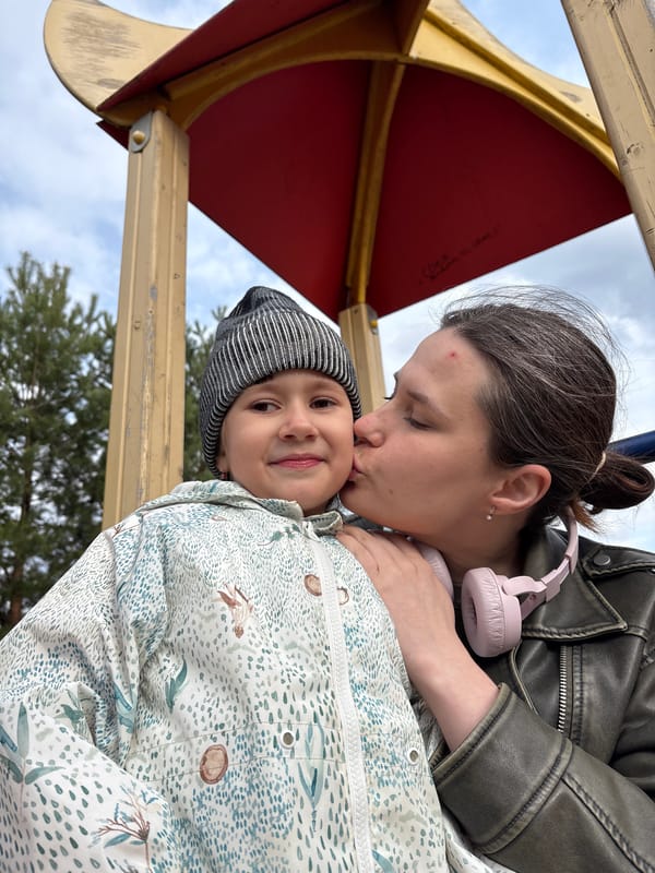 Woman and child share moment on Chaikovsky playground