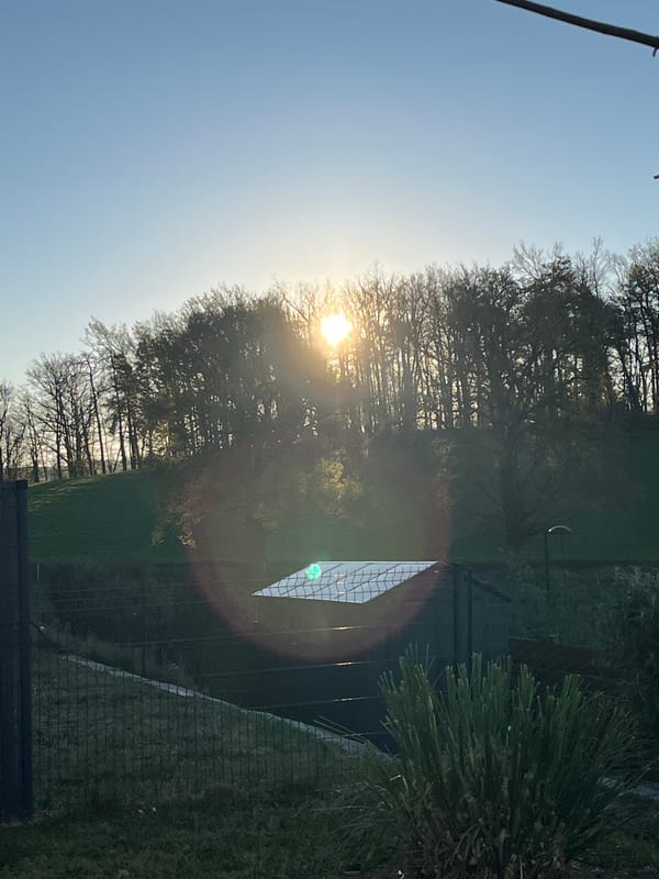 Dawn breaks over Chambœuf with crescent moon visible