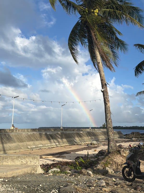 Rainbow appears over General Luna coastline amid cloudy skies