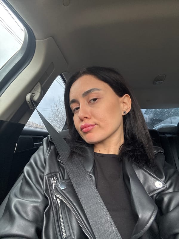 Woman photographed in passenger seat of car in Tbilisi