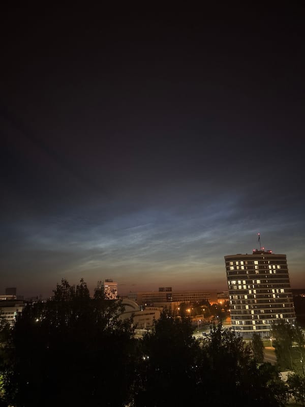Dusk clouds and city lights from an elevated urban lookout