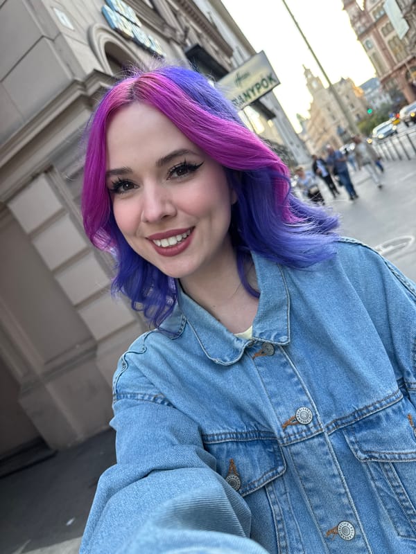 Tourist documents Budapest architecture while taking colorful hair selfies