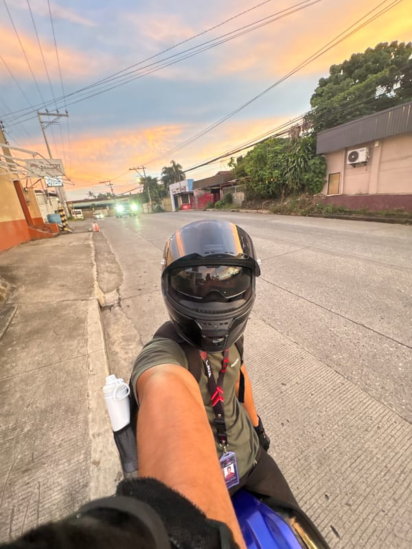 Motorcycle pause in Davao City under a striking sunset sky