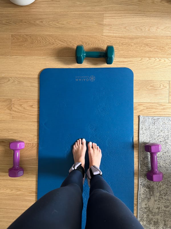 Indoor workout setup documented with yoga mat and weights